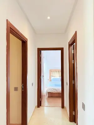 a hallway with two doors leading to a bedroom at Appartement Confortable Vus Sur Piscine A Prestigia in Marrakech