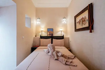 a bedroom with a bed with a stuffed animal on it at Authentic Guesthouse Peral in the heart of Medina in Marrakech