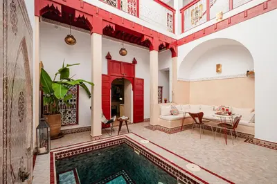 a living room with a pool in the middle of a house at Authentic Guesthouse Peral in the heart of Medina in Marrakech