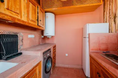 a kitchen with a refrigerator and a washer at Authentic Guesthouse Peral in the heart of Medina in Marrakech
