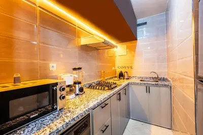 a kitchen with a stove and a counter top at Stylish Apartment in Gueliz by Train And Majorelle in Marrakech