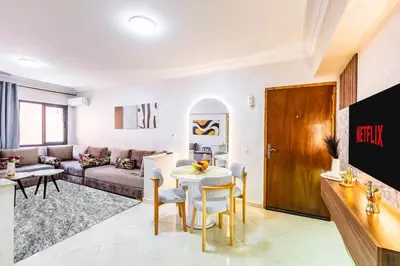 a living room with a couch and a table at Stylish Apartment in Gueliz by Train And Majorelle in Marrakech