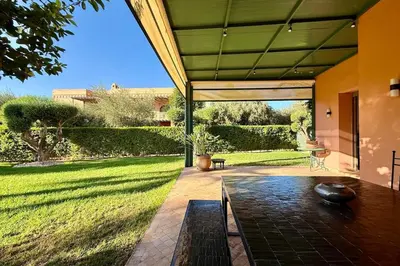 an external view of a house with a patio at Apartment with big private garden in Palmeraie in Marrakech