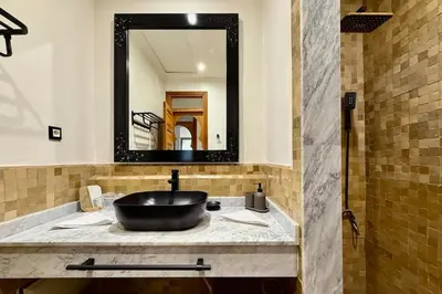 a bathroom with a sink and a mirror at Apartment with big private garden in Palmeraie in Marrakech