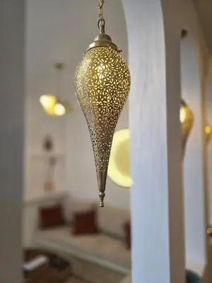 a chandelier hanging from a wall in a room at Riad Alaya by Maison Amellal in Marrakech