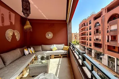 a balcony with a couch and a table on a building at 2 bedroom apartment in Plaza central Gueliz in Marrakech