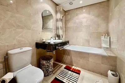 a bathroom with a toilet and a sink and a tub at 2 bedroom apartment in Plaza central Gueliz in Marrakech