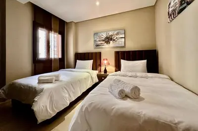 two beds sitting next to each other in a bedroom at 2 bedroom apartment in Plaza central Gueliz in Marrakech
