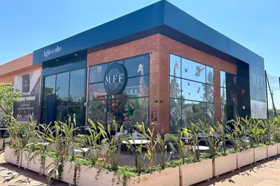 a restaurant with plants in front of a building at Domaine de Noria with terrace and Pools in Marrakech
