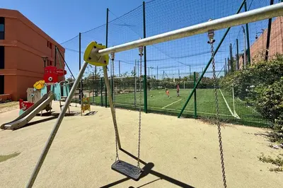 a swing set in a playground with people playing at Domaine de Noria with terrace and Pools in Marrakech