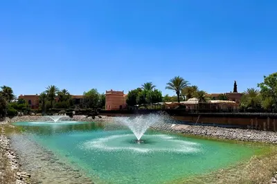 a fountain in the middle of a pond at Garden Aparment in Palmeraie 2 in Marrakech