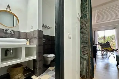 a bathroom with a sink and a toilet and a mirror at Garden Aparment in Palmeraie 2 in Marrakech