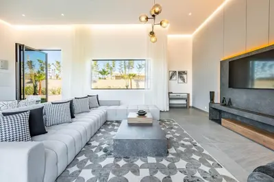 a living room with a couch and a tv at Prestige Twin Villa with Splendid View in Marrakech