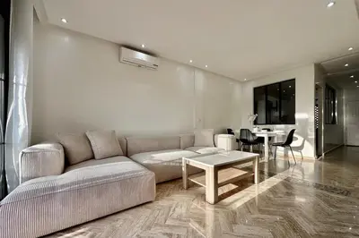 a living room with a couch and a table at Atlas Golf Resort with Terrace and Pools in Marrakech