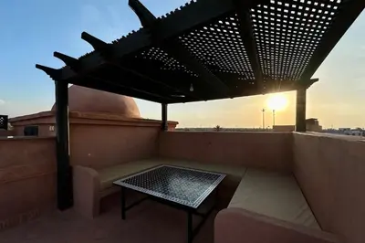 a bench and a table on a roof at Atlas Golf Resort with Terrace and Pools in Marrakech