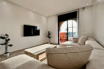 a living room with two couches and a tv at Atlas Golf Resort with Terrace and Pools in Marrakech