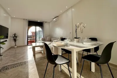 a dining room with a white table and chairs at Atlas Golf Resort with Terrace and Pools in Marrakech