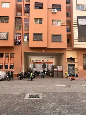 a large building with motorcycles parked in front of it at Modern Apt 10min Airport Balcony & Wi-Fi in Marrakech
