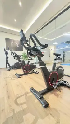 a gym with three exercise bikes on the floor at New Appart cosy et raffiné avec piscine et Jacuzzi à Guéliz in Marrakech