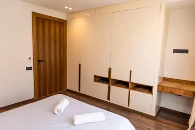 a bedroom with a white bed and a closet at Villa terracotta in Marrakech