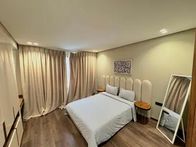 a bedroom with a white bed and a mirror at Villa terracotta in Marrakech