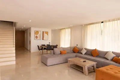 a living room with a couch and a table at Villa terracotta in Marrakech