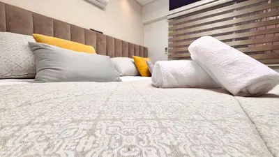 a bedroom with a large white bed with pillows at Duplex Élégance et Confort avec piscine au Cœur de Marrakech in Marrakech