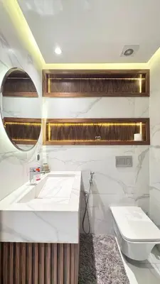 a white bathroom with a sink and a toilet at Duplex Élégance et Confort avec piscine au Cœur de Marrakech in Marrakech