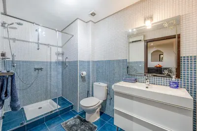a bathroom with a toilet and a shower and a sink at Majorelle Place in Marrakech