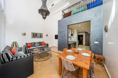 a living room with a table and a couch at Majorelle Place in Marrakech