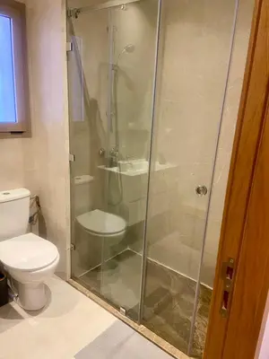 a shower stall in a bathroom with a toilet at prestigia urbane appartement marrakech in Marrakech