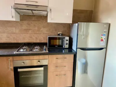 a kitchen with a refrigerator and a microwave at prestigia urbane appartement marrakech in Marrakech