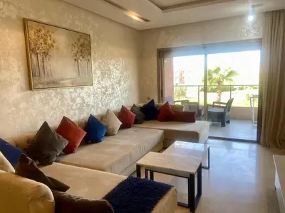 a living room with two couches and a table at prestigia urbane appartement marrakech in Marrakech