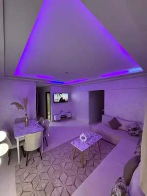 a purple living room with a couch and a table at Appartement Marrakech route de casa in Marrakech