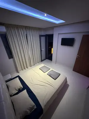a bedroom with a bed and a blue light at Appartement Marrakech route de casa in Marrakech