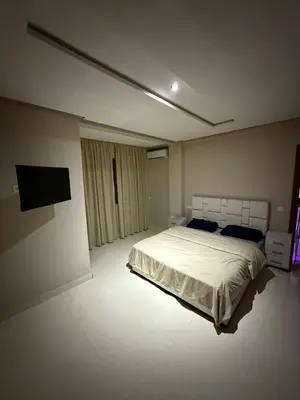 a bedroom with a bed and a flat screen tv at Appartement Marrakech route de casa in Marrakech