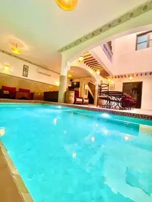 a large swimming pool in a hotel room at Riad alwafa B&B in Marrakech