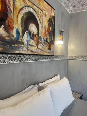 a painting hanging above a bed in a bedroom at Riad alwafa B&B in Marrakech