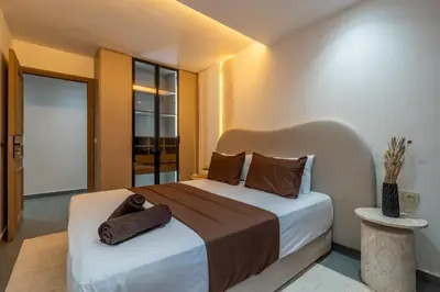 a bedroom with a bed with a towel on it at Spacieux 2BR à Guéliz, Centre-Ville, Moderne et Confortable in Marrakech