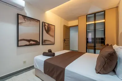 a bedroom with a bed and two pictures on the wall at Spacieux 2BR à Guéliz, Centre-Ville, Moderne et Confortable in Marrakech