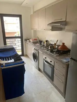 a kitchen with a stove and a washing machine at Marrakech Apartment with Pool in Marrakech