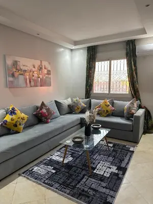 a living room with a couch and a table at Modern and quit appartment in Marrakech