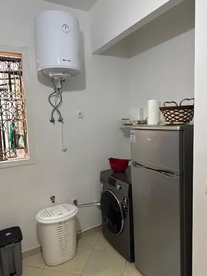 a kitchen with a washing machine and a window at Modern and quit appartment in Marrakech