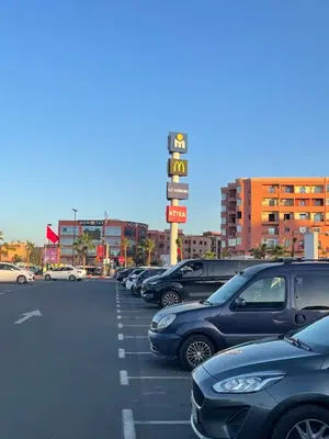 a parking lot with a lot of cars parked at Modern and quit appartment in Marrakech