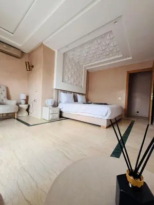 a large bedroom with a bed and a couch at Villa Akenza Marrakech in Marrakech