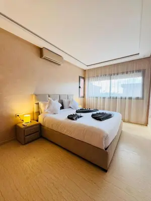 a bedroom with a large bed and a window at Villa Akenza Marrakech in Marrakech