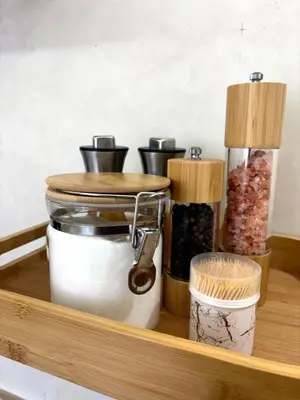 a wooden shelf with spices and containers on it at Dar Kamyssa Le désert au cœur de Guéliz in Marrakech
