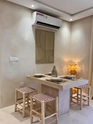 a kitchen with a counter with stools and a stove at Dar Kamyssa Le désert au cœur de Guéliz in Marrakech