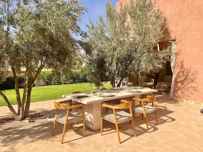 a table and chairs sitting on a patio at Villa AYA - Moderne & Chic in Sraghna