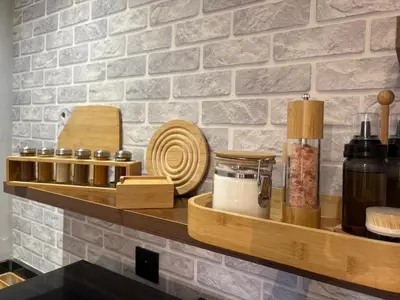 a counter with wooden shelves and dishes on a wall at Cozy Urban Haut Standing au cœur de Guéliz in Marrakech